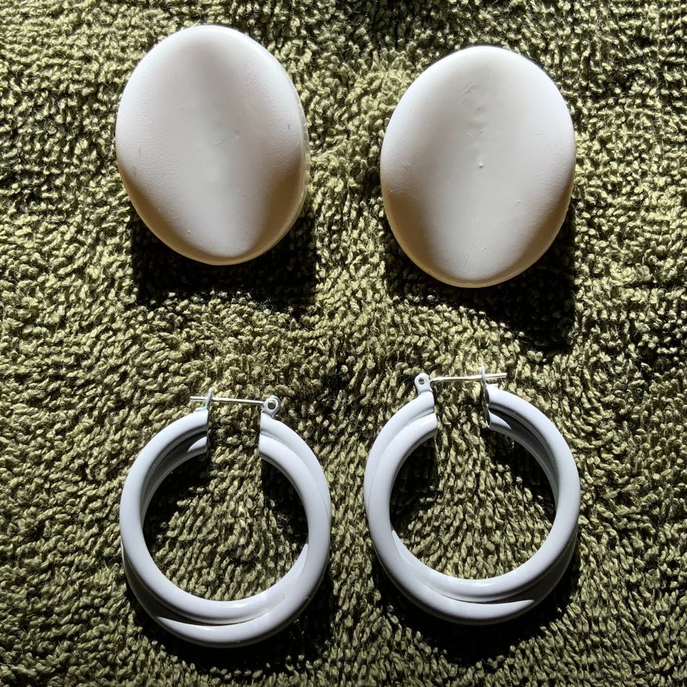 Two pair of white colored pierced earrings; Oval & Hoop